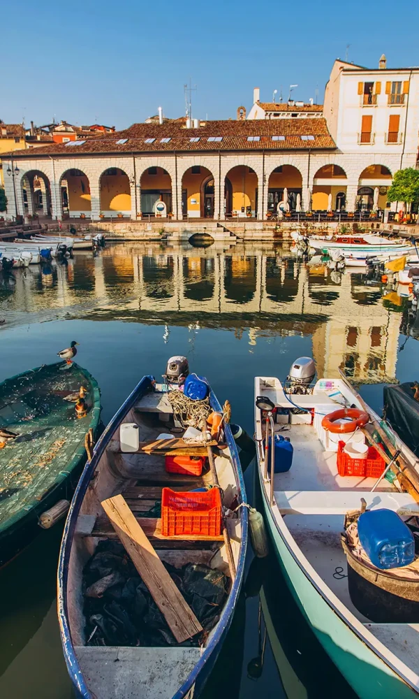 A picturesque harbor with boats, surrounded by colorful buildings.